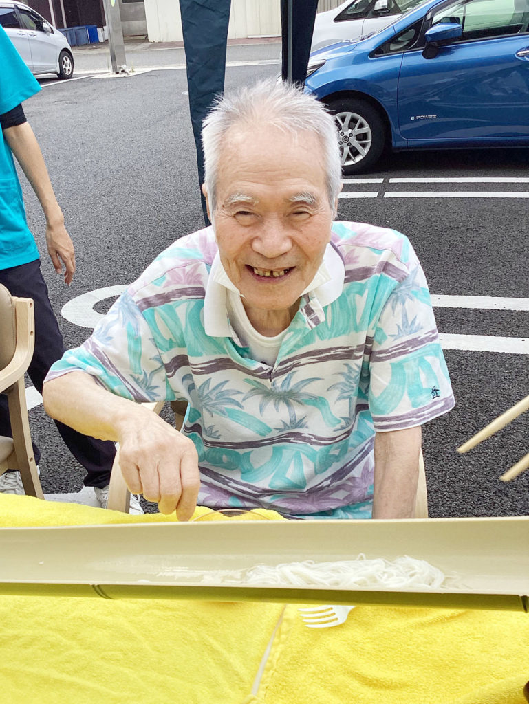 流しそうめんを前に笑顔の利用者さま